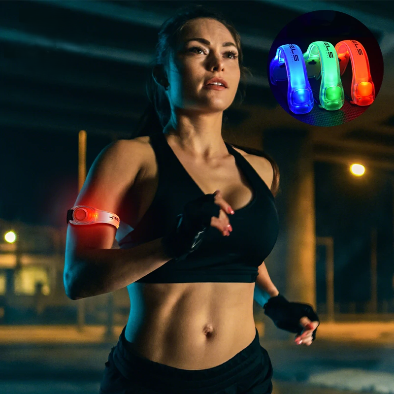 Woman running at night with glowing arm bands