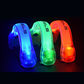 Three glowing runner's safety wristbands in blue, green, and red lights on a dark background